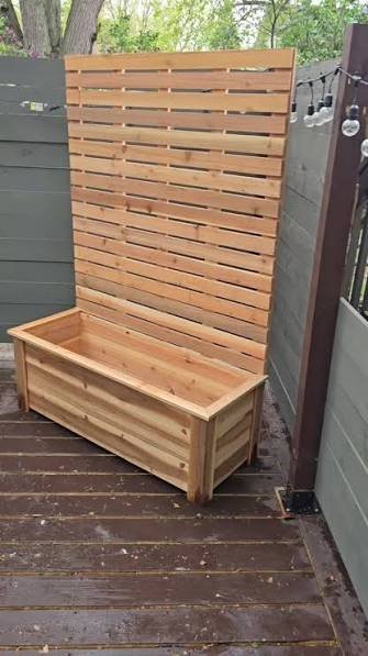 Cedar slat privacy screen built above a matching timber planter box, by GP FloraL in Penang