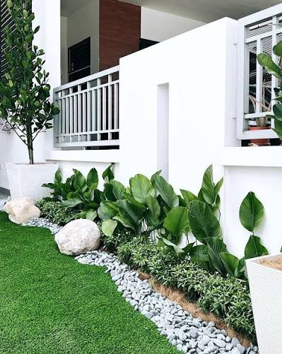 Residential front garden in Penang with tropical foundation planting and a white pebble border, by GP FloraL