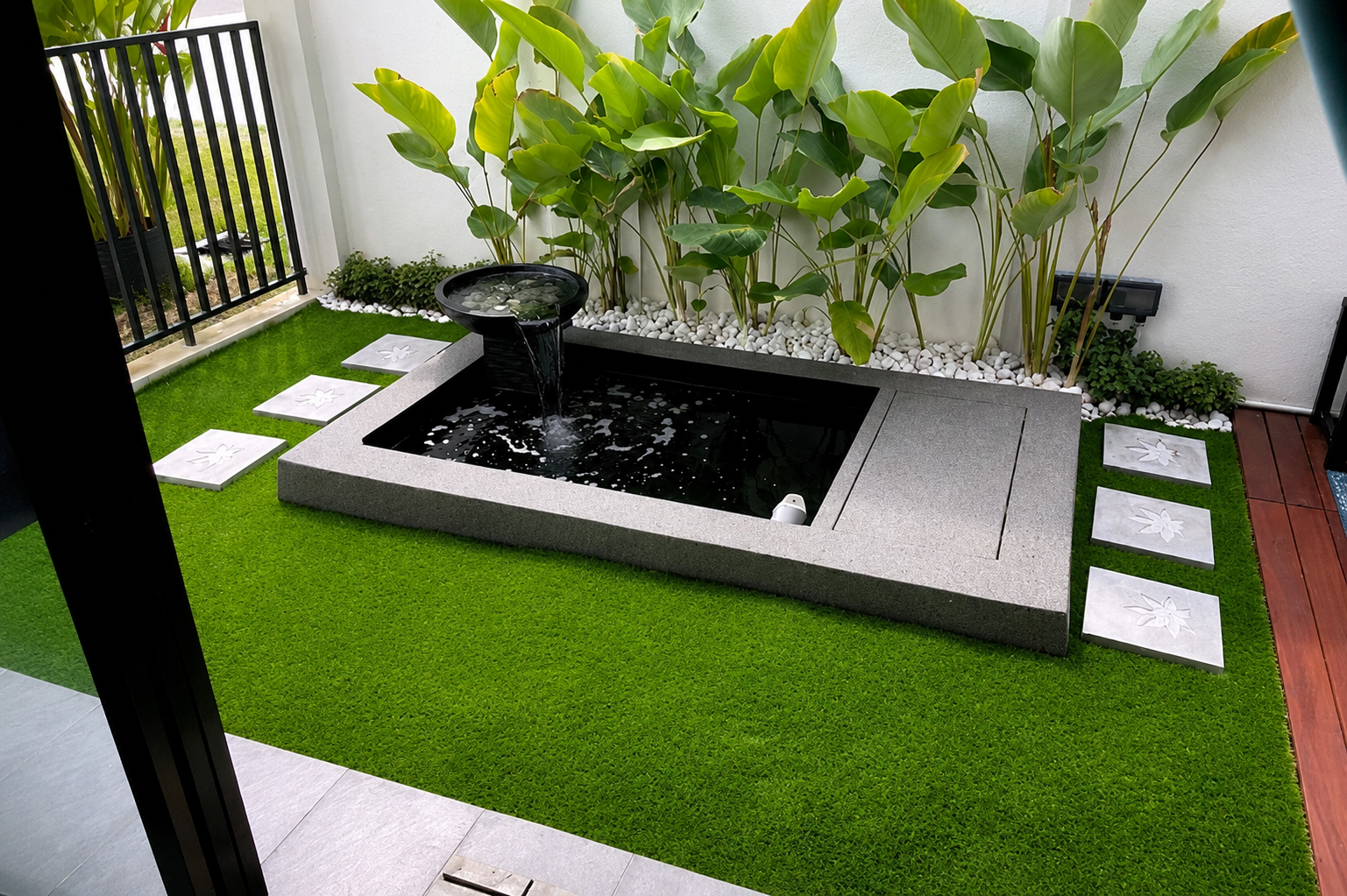 Modern garden pond with water plants and stepping stones, built by GP FloraL in Penang