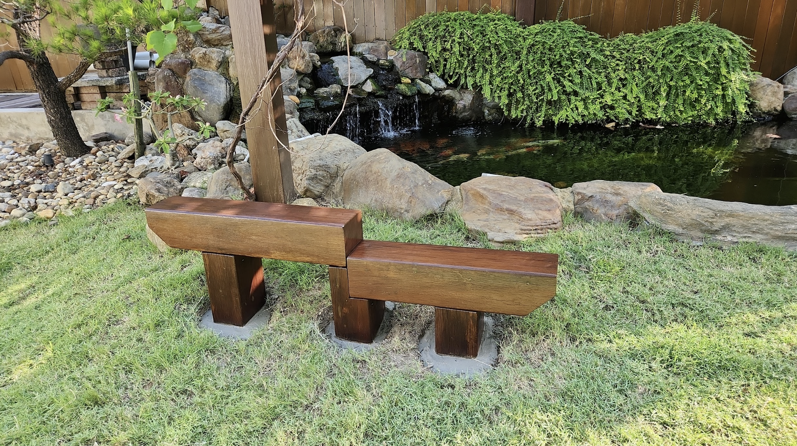 Timber deck and bench beside a garden pond in Penang, by GP FloraL